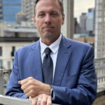 Photo of Florida Personal Injury Lawyer Tim Nies who handles motorcycle accident cases wearing a blue suit